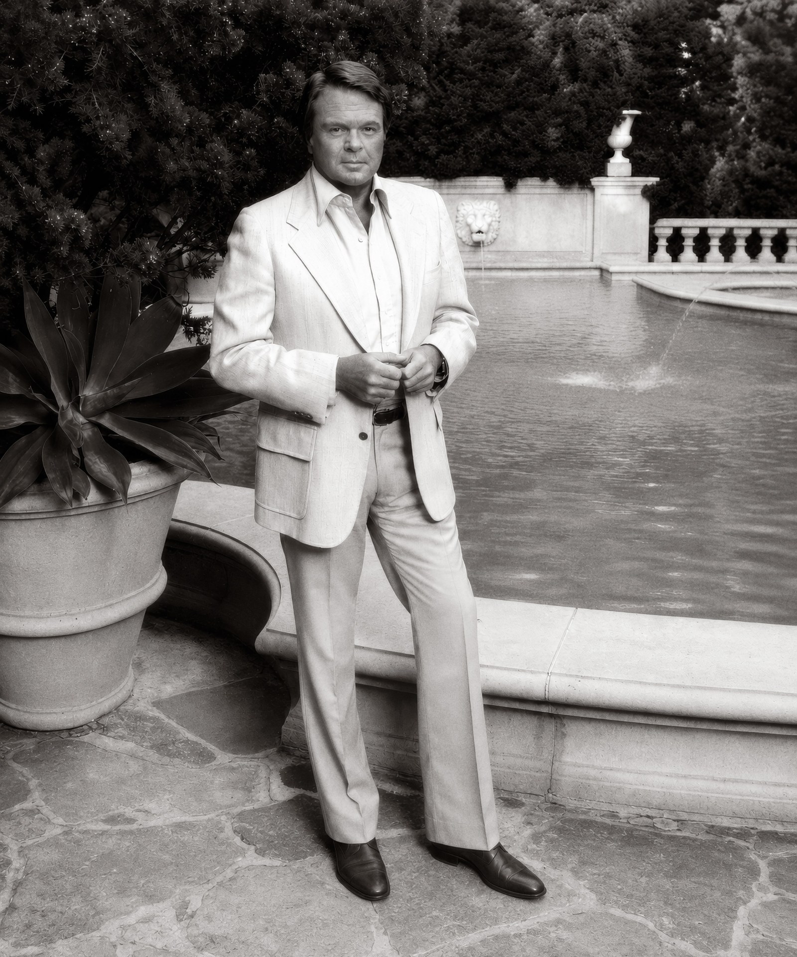 Michael Taylor standing beside a garden fountain